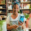 Credit card, pos payment or florist woman, startup small business owner or manager with retail sales product. Commerce shopping service, flower store or African worker with financial fintech purchase